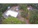 Sprawling property featuring a home with metal roof, a vehicle, outbuildings and surrounded by lush greenery at 11921 Se 169Th Avenue Rd, Ocklawaha, FL 32179