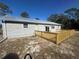 Exterior of home with a new wooden deck in the backyard at 11921 Se 169Th Avenue Rd, Ocklawaha, FL 32179