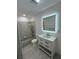 Modern bathroom with updated vanity, sleek mirror and tub at 11921 Se 169Th Avenue Rd, Ocklawaha, FL 32179