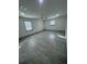 Spacious bedroom with gray floors, a ceiling fan, and natural light from two windows at 11921 Se 169Th Avenue Rd, Ocklawaha, FL 32179