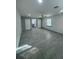 Spacious bedroom with gray floors, a ceiling fan, and natural light from the window at 11921 Se 169Th Avenue Rd, Ocklawaha, FL 32179