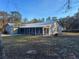 Charming single-story home with a screened-in porch and a lush green lawn at 11921 Se 169Th Avenue Rd, Ocklawaha, FL 32179