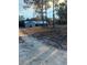 Distant view of a quaint home with metal roof, screened porch, and a spacious yard at 11921 Se 169Th Avenue Rd, Ocklawaha, FL 32179