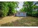 Simple backyard featuring a single-story home, grass, and mature trees at 1325 42Nd St, Orlando, FL 32839