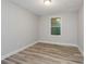 A bedroom with gray walls, modern flooring, and one new window at 1325 42Nd St, Orlando, FL 32839