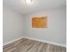 Cozy bedroom offers new modern flooring, neutral paint, and a window letting in natural light, creating a serene space at 1325 42Nd St, Orlando, FL 32839