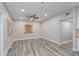 Spacious living room showcasing neutral gray walls, modern flooring, ceiling fan, and natural light from the adjacent spaces at 1325 42Nd St, Orlando, FL 32839