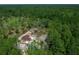 Aerial view of a brown roof home with a large wooded lot at 13491 E Hwy 316, Fort Mc Coy, FL 32134