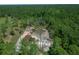 Aerial view of a brown roof home with a large wooded lot at 13491 E Hwy 316, Fort Mc Coy, FL 32134