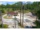 Aerial view of a newly constructed home in a wooded setting at 13491 E Hwy 316, Fort Mc Coy, FL 32134