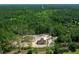 Aerial view of a brown roof home with a large wooded lot and a road in the background at 13491 E Hwy 316, Fort Mc Coy, FL 32134