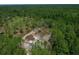 Aerial view of a brown roof home with a large wooded lot at 13491 E Hwy 316, Fort Mc Coy, FL 32134