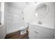 Bright bathroom featuring a sleek white vanity, commode and a shower with tiled walls at 13491 E Hwy 316, Fort Mc Coy, FL 32134