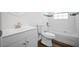 Bathroom showcasing a white vanity, commode, and tiled shower/tub combination with accent tile at 13491 E Hwy 316, Fort Mc Coy, FL 32134