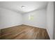 Bedroom featuring wood-look flooring, natural light, and neutral walls and trim at 13491 E Hwy 316, Fort Mc Coy, FL 32134
