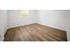 Bedroom with wood-look floors, neutral paint, natural light, and crisp white trim at 13491 E Hwy 316, Fort Mc Coy, FL 32134