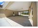 Large covered carport with concrete flooring, featuring a door leading to the backyard and recessed lighting at 13491 E Hwy 316, Fort Mc Coy, FL 32134