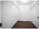 Spacious walk-in closet with white walls, wood-look flooring, and wire shelving at 13491 E Hwy 316, Fort Mc Coy, FL 32134