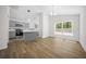 Open dining and kitchen area with an island, gray cabinets, and modern lighting at 13491 E Hwy 316, Fort Mc Coy, FL 32134