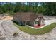 Newly built single Gathering home with beige siding, brown roof and professional landscaping at 13491 E Hwy 316, Fort Mc Coy, FL 32134