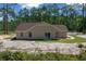 Rear view of a cozy house with manicured landscaping and sliding glass door access at 13491 E Hwy 316, Fort Mc Coy, FL 32134
