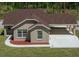 A high angle view of this one-story home shows the attached carport and neutral stucco exterior finish at 13491 E Hwy 316, Fort Mc Coy, FL 32134