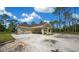 Single-story home with a covered carport, set on a spacious lot with lush greenery and natural wooded surroundings at 13491 E Hwy 316, Fort Mc Coy, FL 32134
