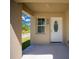 Well-lit front entrance featuring a decorative door, adjacent window, and clear numbering for easy identification at 13491 E Hwy 316, Fort Mc Coy, FL 32134