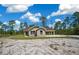 Charming one-story home featuring a covered carport and a well-manicured lawn against a picturesque wooded backdrop at 13491 E Hwy 316, Fort Mc Coy, FL 32134