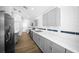 Modern kitchen with stainless steel appliances, gray cabinets, and white subway tile backsplash at 13491 E Hwy 316, Fort Mc Coy, FL 32134