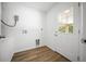 Inside laundry room with white walls, tiled floor, and exterior door at 13491 E Hwy 316, Fort Mc Coy, FL 32134
