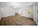 Bright living room with wood floors, chandelier, and large window letting in natural light at 13491 E Hwy 316, Fort Mc Coy, FL 32134