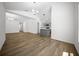 Bright living room that features wood floors and flows into the kitchen at 13491 E Hwy 316, Fort Mc Coy, FL 32134