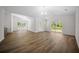 Open concept living room with wood floors, high ceilings, and sliding glass door at 13491 E Hwy 316, Fort Mc Coy, FL 32134