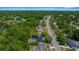 An aerial view showcasing a home in a lush, green neighborhood, complete with a screened pool, and mature trees at 14476 Sw 43Rd Court Rd, Ocala, FL 34473