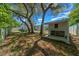 A serene backyard oasis with mature trees, a pool enclosure, and a shed, offering privacy and space for outdoor enjoyment at 14476 Sw 43Rd Court Rd, Ocala, FL 34473