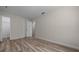 Well-lit bedroom featuring wood-look flooring, neutral paint, and convenient access to a closet at 14476 Sw 43Rd Court Rd, Ocala, FL 34473
