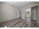 The bedroom has wood-look flooring, fresh white walls and sliding mirror closet doors at 14476 Sw 43Rd Court Rd, Ocala, FL 34473