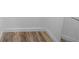 Walk-in closet has wood-look flooring, white walls and baseboards, and a white wire shelf at 14476 Sw 43Rd Court Rd, Ocala, FL 34473