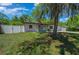 Landscaped home featuring a fenced yard with mature trees and a new driveway at 14476 Sw 43Rd Court Rd, Ocala, FL 34473