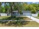 Attractive single-story home with a fresh concrete driveway, fenced yard and mature tree at 14476 Sw 43Rd Court Rd, Ocala, FL 34473