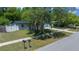 Well-manicured front yard with green lawn, mature tree, mailbox and sidewalk on a sunny day at 14476 Sw 43Rd Court Rd, Ocala, FL 34473
