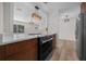 Modern kitchen featuring quartz countertops, stainless steel oven, and modern hanging lights at 14476 Sw 43Rd Court Rd, Ocala, FL 34473