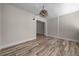 Open-concept living room with wood-look flooring, modern lighting, and a seamless transition to other spaces at 14476 Sw 43Rd Court Rd, Ocala, FL 34473