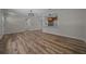 Open-concept living space featuring wood-look floors, updated lighting, and easy kitchen access at 14476 Sw 43Rd Court Rd, Ocala, FL 34473