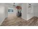 Open-concept living space with wood-look flooring, modern lighting, and stainless steel refrigerator at 14476 Sw 43Rd Court Rd, Ocala, FL 34473