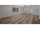A sunny living room with wood-look floors, fresh paint, and large window providing ample light at 14476 Sw 43Rd Court Rd, Ocala, FL 34473