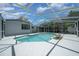 A screened-in pool surrounded by a spacious deck with comfortable seating, perfect for relaxing and enjoying the outdoors at 14476 Sw 43Rd Court Rd, Ocala, FL 34473