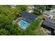 Aerial shot showcasing a beautiful, screened-in pool surrounded by well-maintained landscaping in a private backyard at 14476 Sw 43Rd Court Rd, Ocala, FL 34473