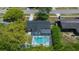 An aerial view of a home with a screened-in pool, skylights, and mature trees providing privacy at 14476 Sw 43Rd Court Rd, Ocala, FL 34473
